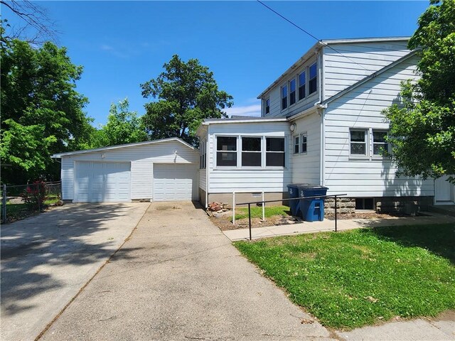 203 N E St, Olney, IL 62450 - view of front of house featuring an outbuilding and a garage