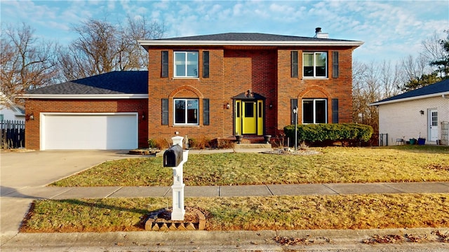 view of front facade with a garage and a front yard