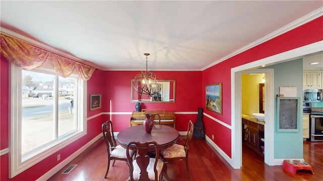 dining room with plenty of natural light, an inviting chandelier, and dark hardwood / wood-style flooring