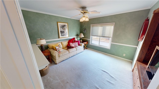 living area featuring ceiling fan, ornamental molding, carpet flooring, and baseboards