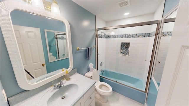 full bath with toilet, bath / shower combo with glass door, vanity, and visible vents