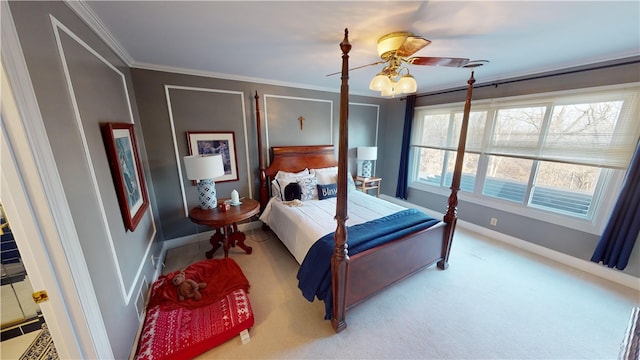 bedroom featuring carpet floors, baseboards, ornamental molding, and a ceiling fan