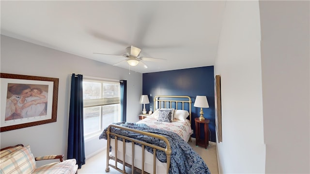 bedroom with a ceiling fan and light colored carpet