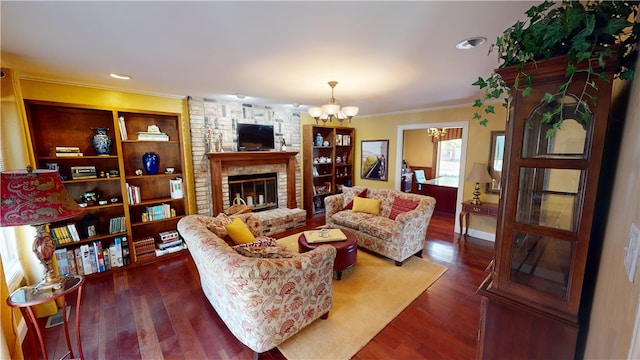 living room with a chandelier, dark wood-style flooring, a fireplace, and crown molding