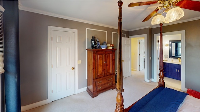 bedroom with light colored carpet, ornamental molding, a sink, ensuite bath, and baseboards