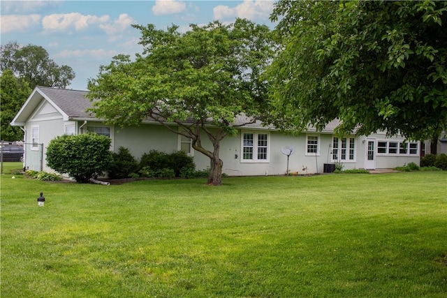 313 Shimp St, Cerro Gordo Township, IL 61855 - rear view of property featuring a lawn and stucco siding