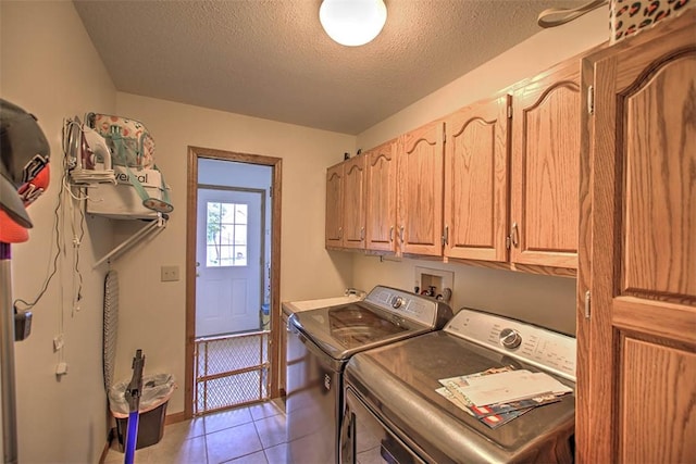 7950 Lehman Rd, Decatur, IL 62521 - washroom with cabinet space, washer and clothes dryer, a textured ceiling, and light tile patterned floors