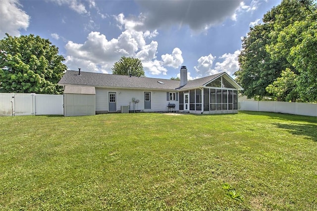 7950 Lehman Rd, Decatur, IL 62521 - rear view of house featuring a sunroom, a fenced backyard, and a chimney