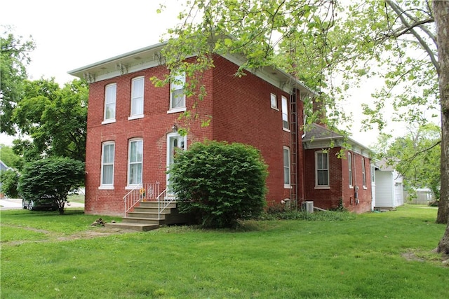 302 W N 3rd St, Shelbyville, IL 62565 - view of home's exterior with brick siding and a yard