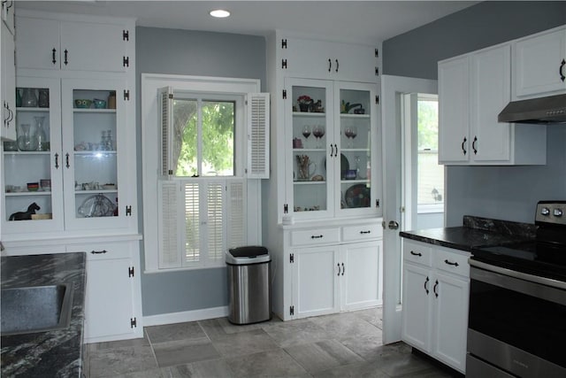 302 W N 3rd St, Shelbyville, IL 62565 - kitchen featuring stainless steel range with electric stovetop, under cabinet range hood, white cabinetry, and dark countertops