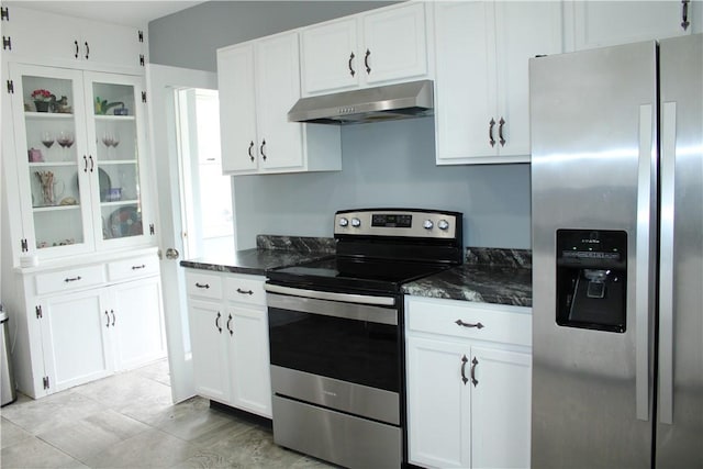 302 W N 3rd St, Shelbyville, IL 62565 - kitchen with stainless steel appliances, under cabinet range hood, white cabinets, dark stone countertops, and glass insert cabinets