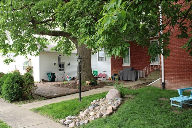 302 W N 3rd St, Shelbyville, IL 62565 - view of side of home with a yard and brick siding