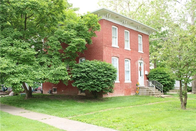302 W N 3rd St, Shelbyville, IL 62565 - view of property exterior featuring a lawn and brick siding