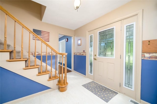 18 Woodmere Dr, Paris, IL 61944 - entryway with plenty of natural light, stairway, and baseboards