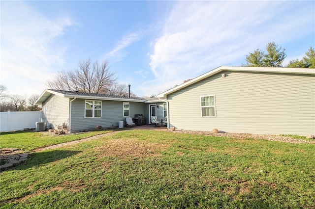 back of property featuring a yard and central AC unit