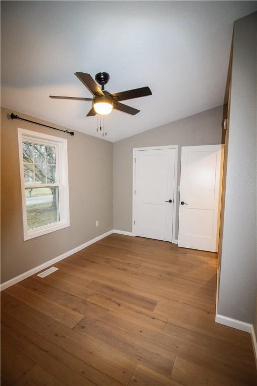 bedroom with lofted ceiling and dark hardwood / wood-style flooring