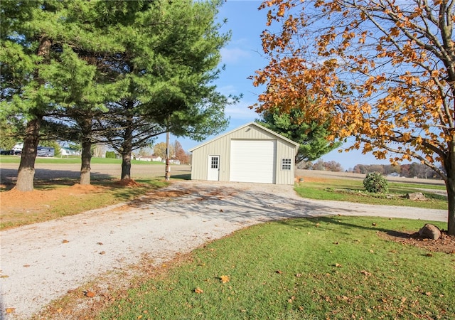 garage featuring a yard and a rural view