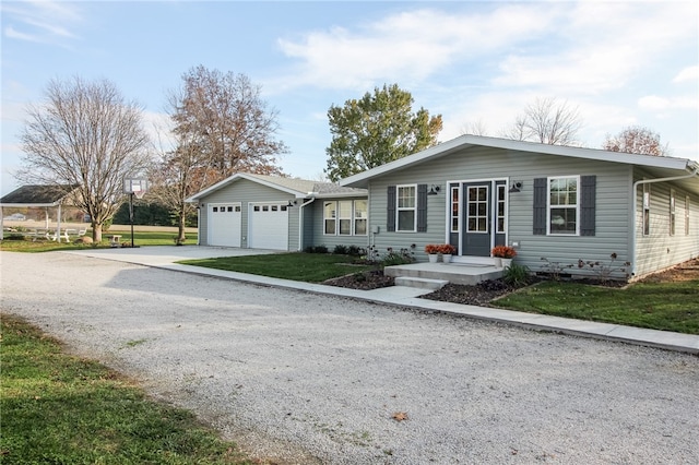 single story home with a garage, an outbuilding, and a front lawn