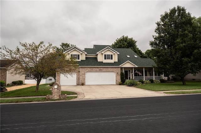 view of front of property featuring a garage and a front lawn