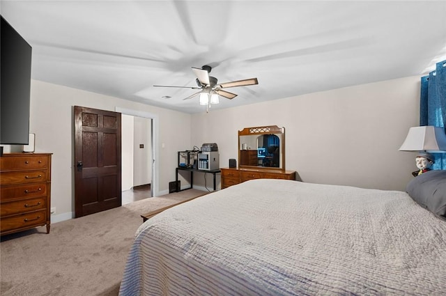 carpeted bedroom featuring ceiling fan and baseboards