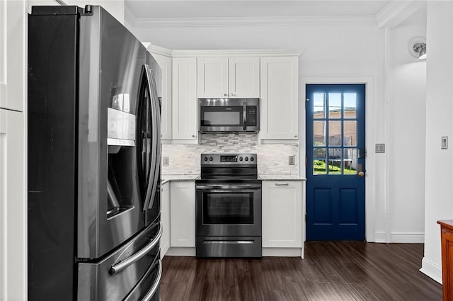 kitchen with tasteful backsplash, appliances with stainless steel finishes, dark wood-style flooring, white cabinetry, and crown molding
