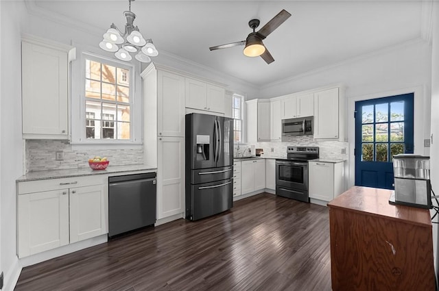 kitchen with tasteful backsplash, stainless steel appliances, white cabinets, and dark wood-style flooring
