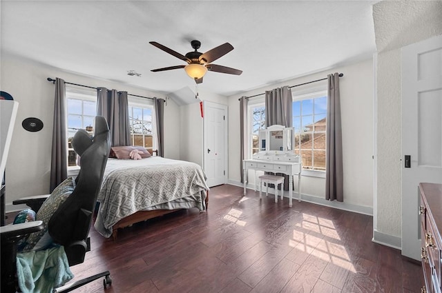 bedroom featuring dark wood-type flooring, ceiling fan, and baseboards