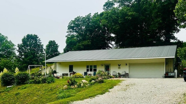 9275 N 890th St, Effingham, IL 62401 - view of front of house featuring a garage, gravel driveway, and a metal roof