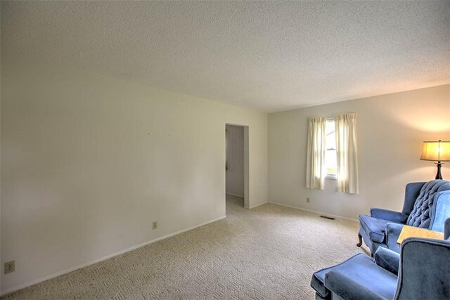 4324 Cleveland Ave, Decatur, IL 62521 - unfurnished living room with carpet floors and a textured ceiling