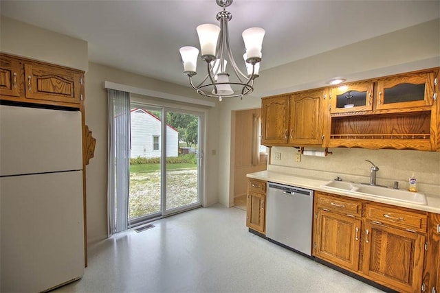 4324 Cleveland Ave, Decatur, IL 62521 - kitchen featuring freestanding refrigerator, stainless steel dishwasher, brown cabinets, light countertops, and a chandelier