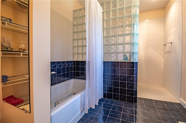 bathroom with walk in shower, a tub to relax in, and tile patterned floors