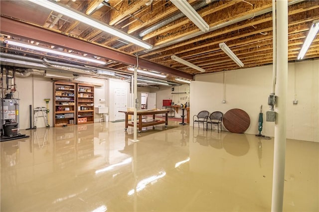 unfinished basement with gas water heater and a sink