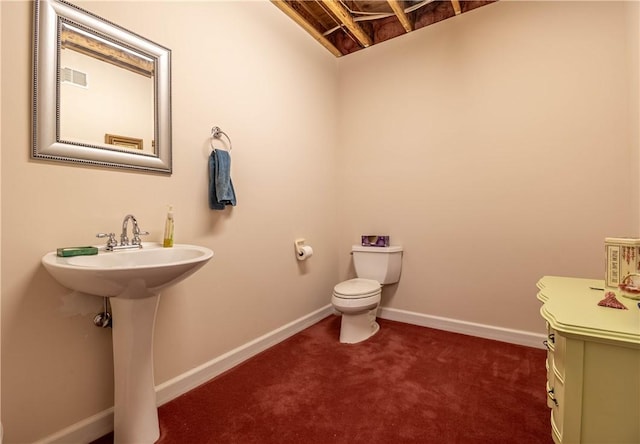 half bath with visible vents, toilet, and baseboards