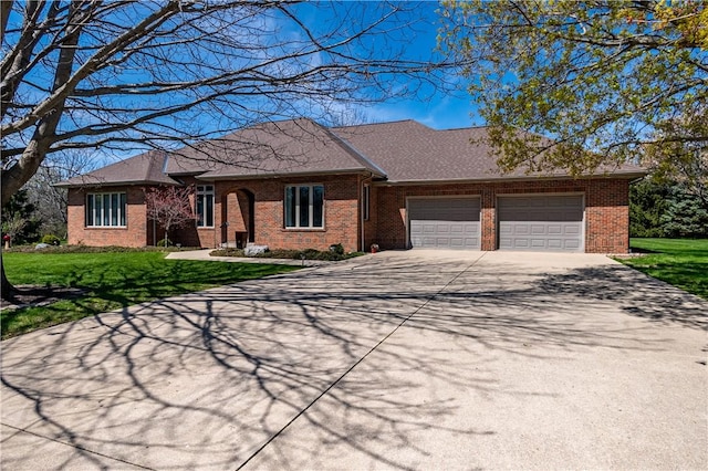 ranch-style house featuring brick siding, a front lawn, driveway, and a garage