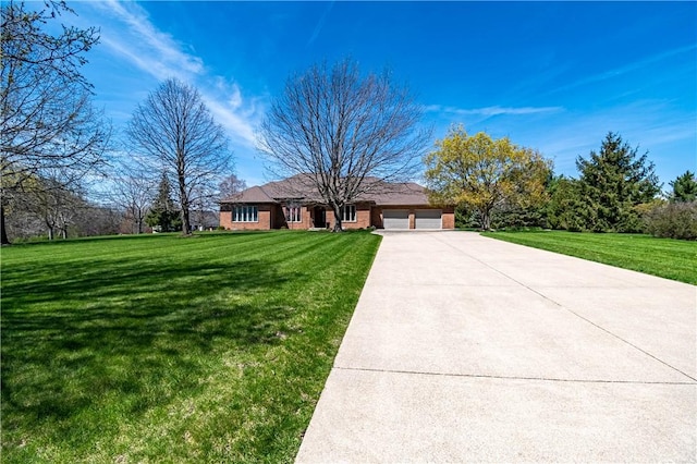 single story home featuring a garage, driveway, a front yard, and brick siding