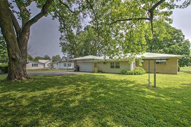 427 S Madison St, Cerro Gordo, IL 61818 - view of front of property with an attached garage, driveway, a front yard, and brick siding