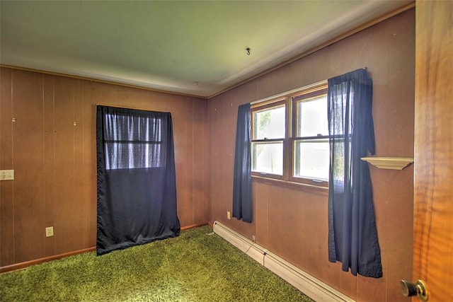 427 S Madison St, Cerro Gordo, IL 61818 - carpeted empty room featuring a baseboard radiator and wood walls