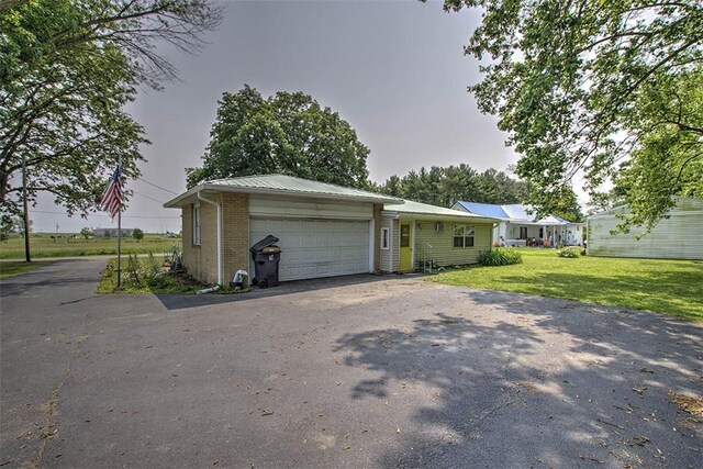 427 S Madison St, Cerro Gordo, IL 61818 - ranch-style home featuring driveway, brick siding, a front yard, and an attached garage