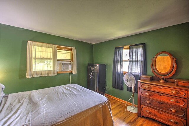 427 S Madison St, Cerro Gordo, IL 61818 - bedroom with wood finished floors, cooling unit, and baseboards