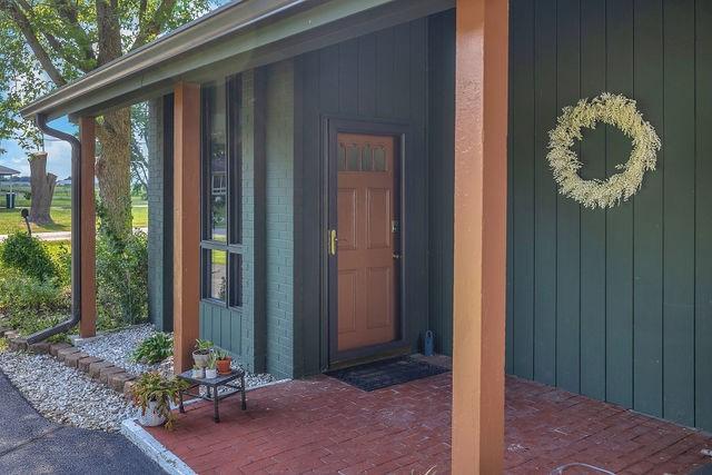 4170 N Taylor Ave, Decatur, IL 62526 - view of exterior entry featuring brick siding and a porch