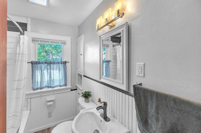 4170 N Taylor Ave, Decatur, IL 62526 - full bathroom with curtained shower and a wainscoted wall