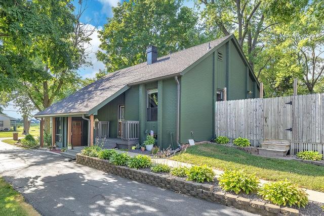 4170 N Taylor Ave, Decatur, IL 62526 - view of home's exterior with a porch, a chimney, and a gate