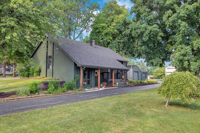 4170 N Taylor Ave, Decatur, IL 62526 - view of front of property with covered porch, a front yard, and a chimney