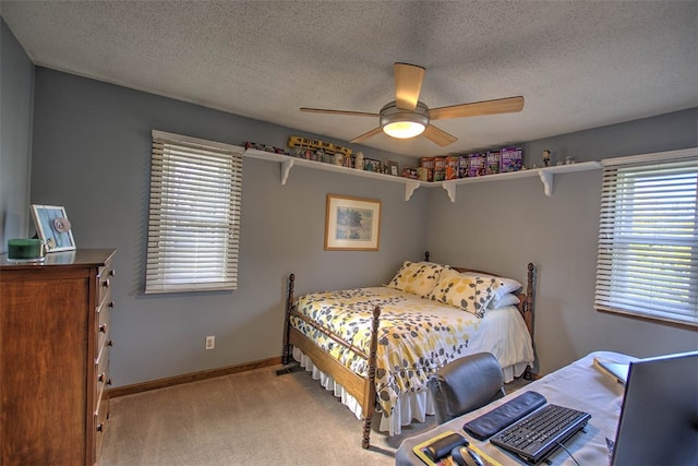 carpeted bedroom with a textured ceiling and ceiling fan