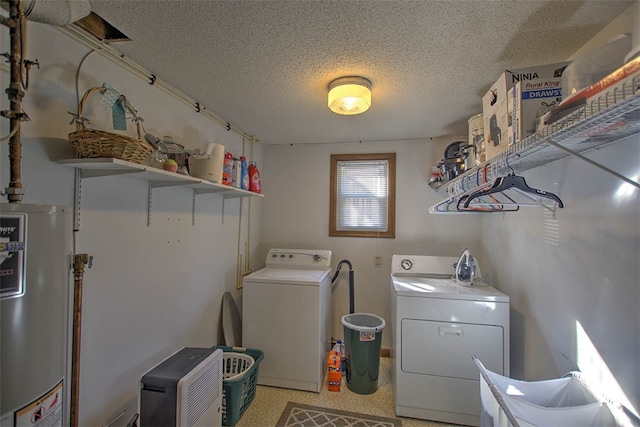 laundry area with washing machine and dryer, a textured ceiling, and water heater