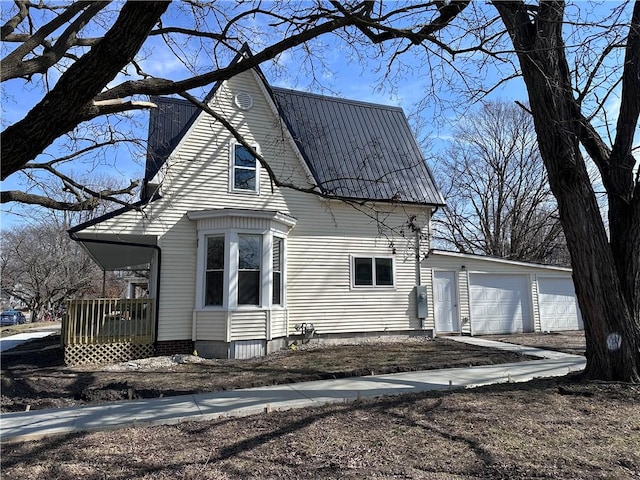 exterior space featuring metal roof and a garage