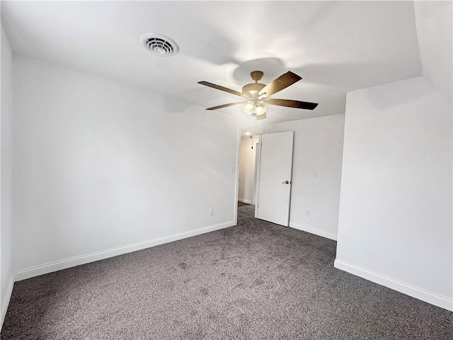 unfurnished room with dark colored carpet, visible vents, baseboards, and a ceiling fan