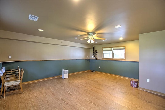 unfurnished room featuring ceiling fan, visible vents, wood finished floors, baseboards, and recessed lighting