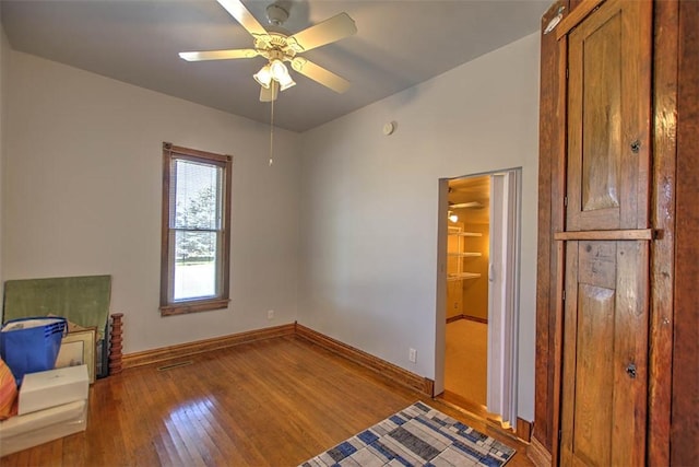 9010 School Rd, Argenta, IL 62501 - interior space featuring baseboards, ceiling fan, and hardwood / wood-style floors