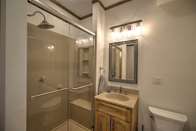 bathroom featuring toilet, ornamental molding, a shower stall, and vanity